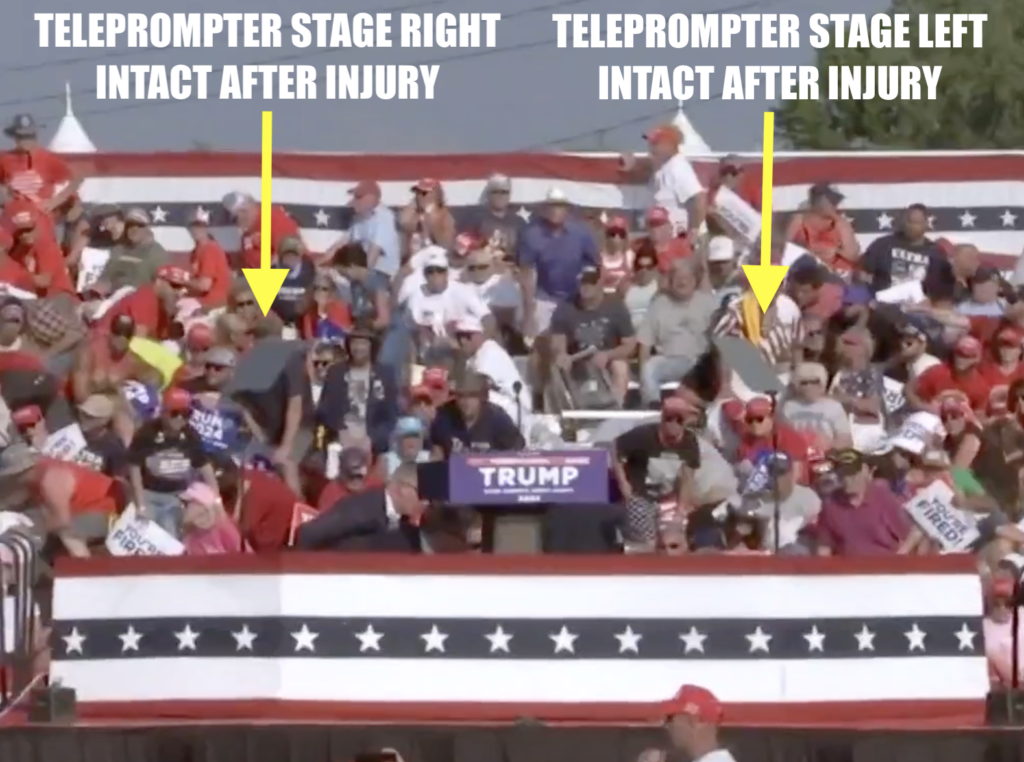 Still frame from NBC News of the shooting, showing both teleprompters upright and apparently fully intact (as in not shattered) _after_ Trump was injured.