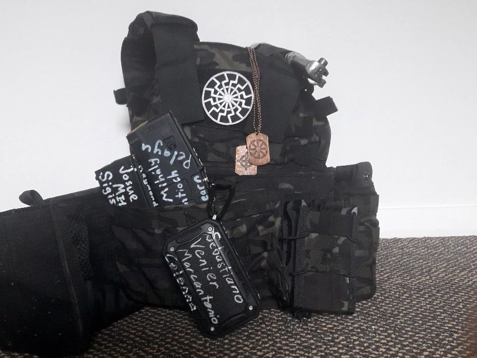 Photograph of Brenton Tarrant's gear showing his Sonnenrad patch and dog tags.