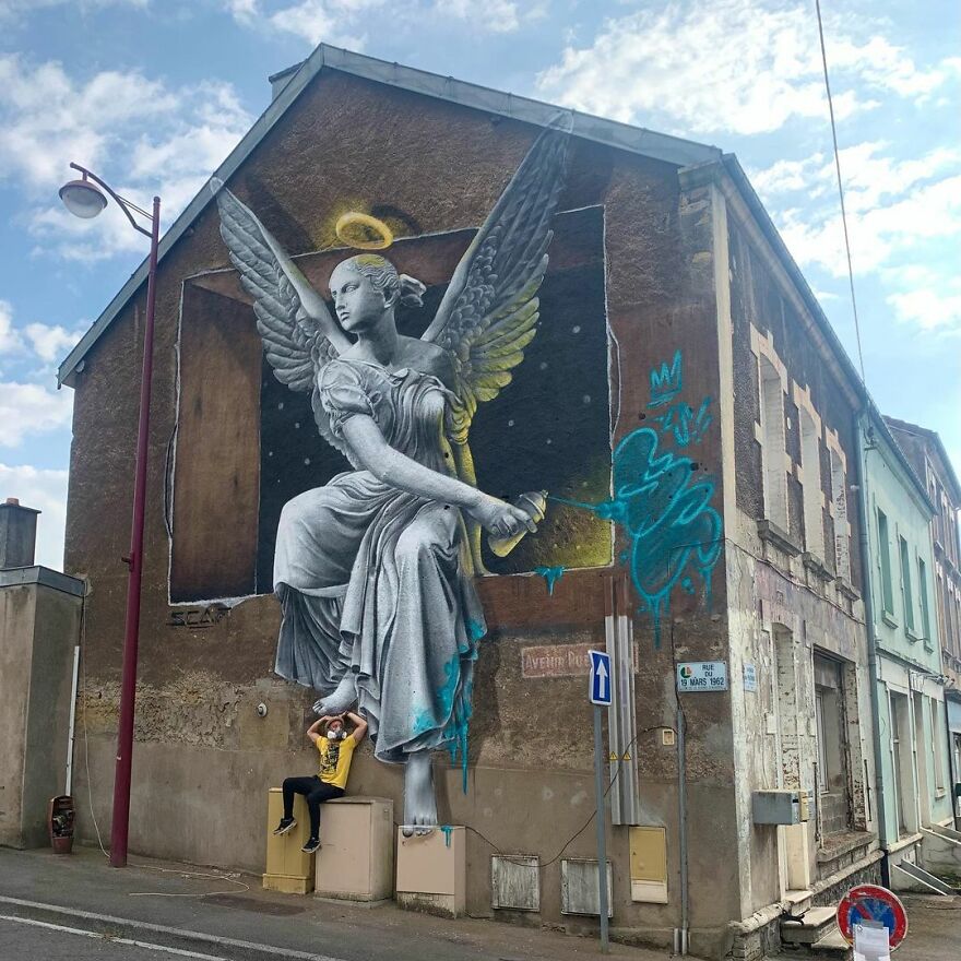 angle spraying on building. 3d mural and graffiti by scaf