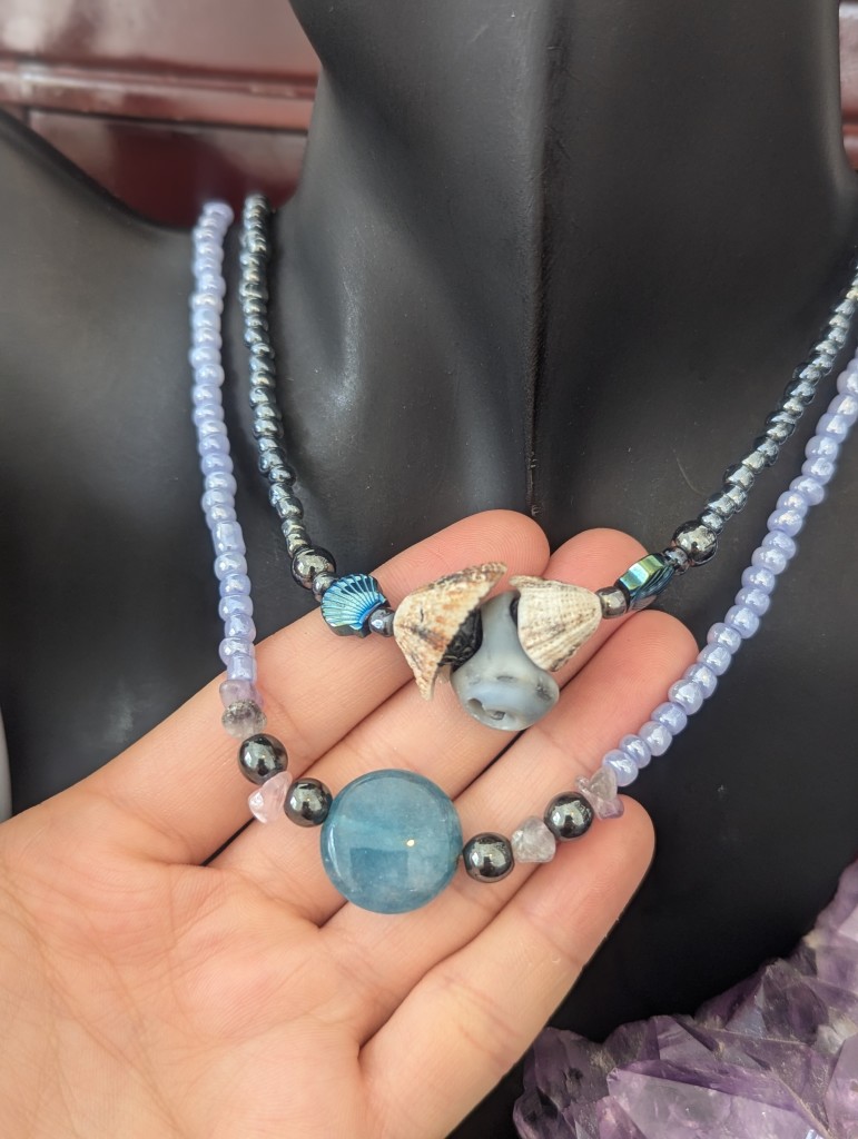 Handmade two necklaces with round agate light blue gemstone and three shells one of them gray blue and the other two white shells and shell-shaped light blue beads and hematite style beads and lots of light blue glass beads and gray glass beads