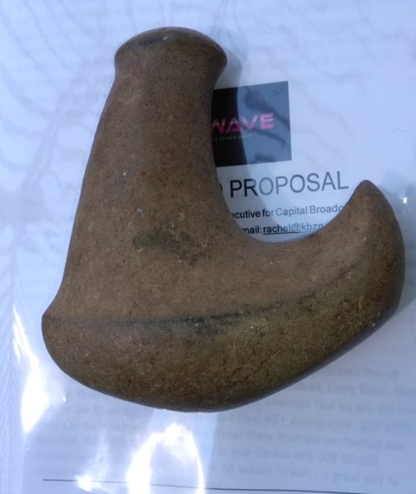 Image of a stone tool that kind of looks like an elf boot I suppose