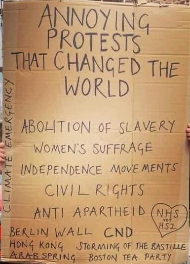 Cardboard placard.
ANNOYING PROTESTS THAT CHANGED THE WORLD
ABOLITION OF SLAVERY
WOMEN'S SUFFRAGE
INDEPENDENCE MOVEMENTS
CIVIL RIGHTS
ANTI-APARTHEID
BERLIN WALL
CND
HONG KONG
ARAB SPRING
BOSTON TEA PARTY
STORMING OF THE BASTILLE
CLIMATE EMERGENCY