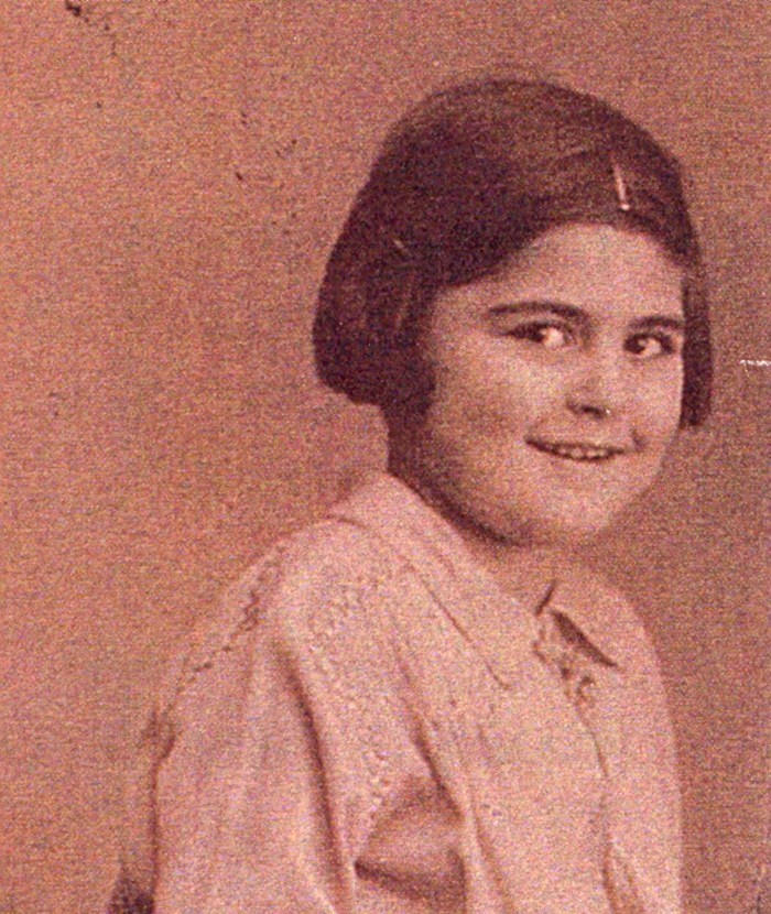 Vintage portrait of a smiling young girl wearing a style blouse.