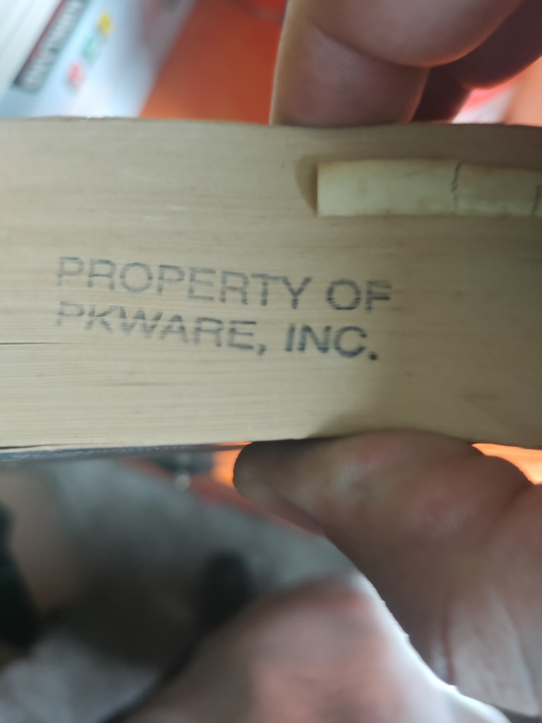 Image depicts the edge of a book. Stamped on the edge: "Property of PKWare, Inc."