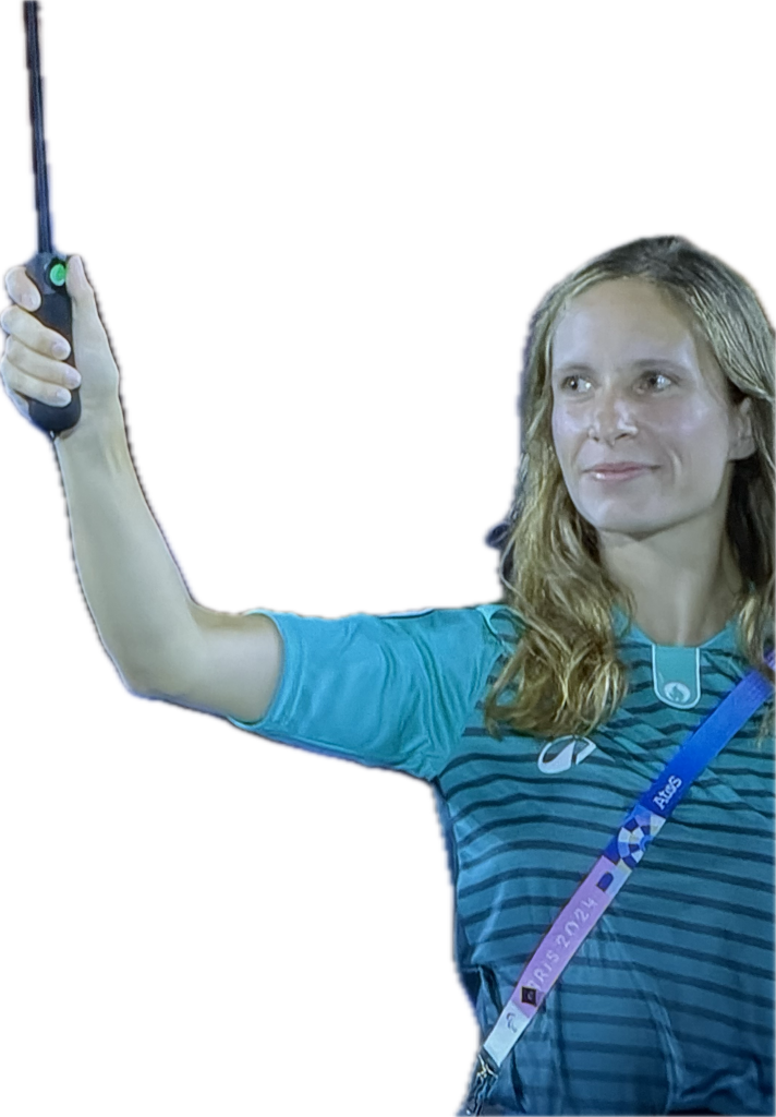 A lady holding an umbrella in Olympic volunteer kit.