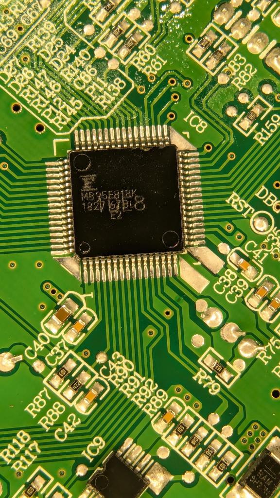 Magnified close up of the main microcontroller in a QFP package