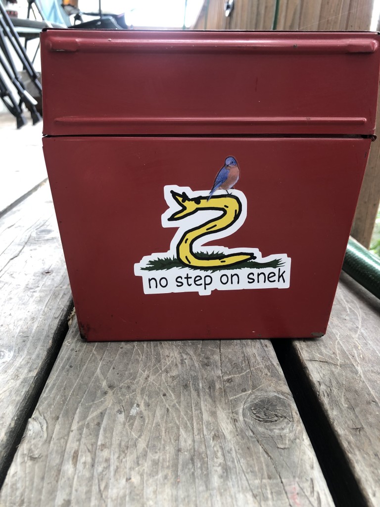 A sticker on my red toolbox, of a poorly drawn yellow snek rising up in anger. “no step on snek!”

I have placed a sticker of a birb standing on his neck.