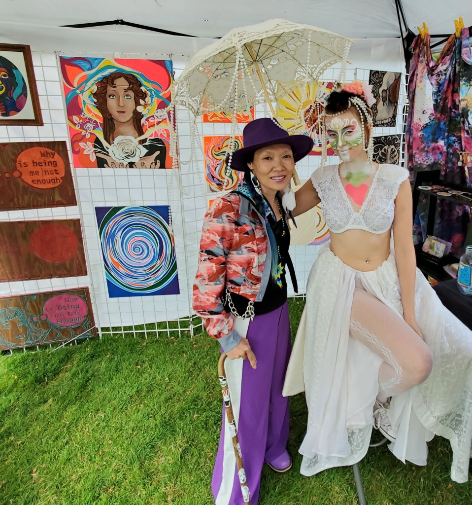 Me, with a bodypainted art model. There's several wood & canvas paintings behind us.