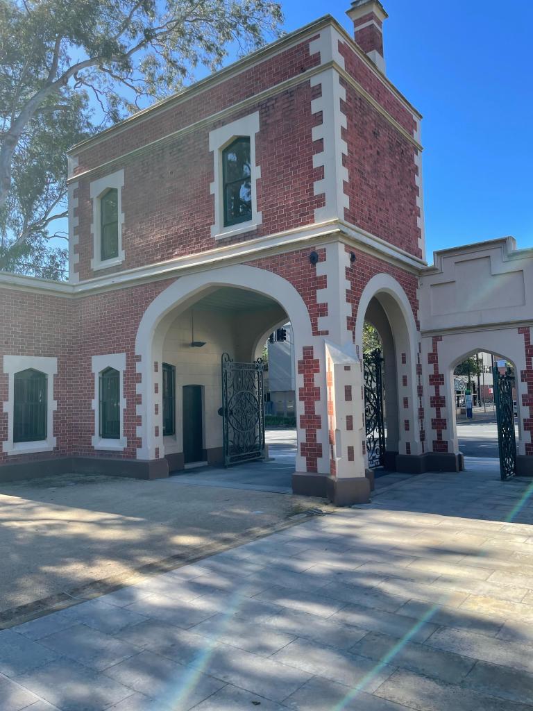 The George St gatehouse, which dates from the colonial era, it’s made from red brick with cream coloured corner features 