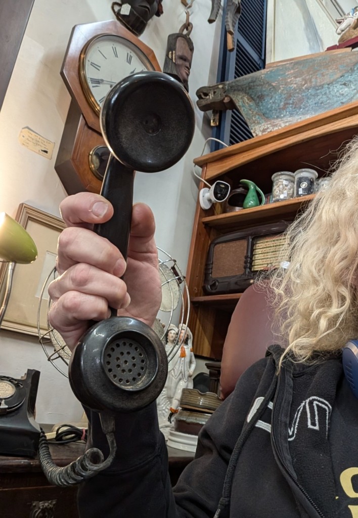 An old bakelite phone in black with my blonde hair