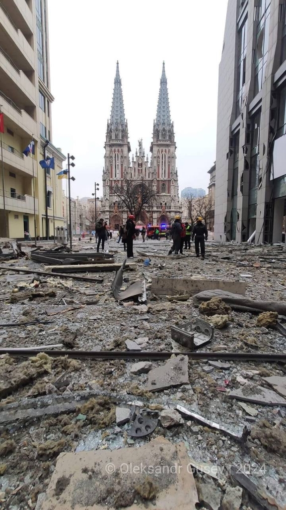 The same church at daylight but the street is all covered in rubble