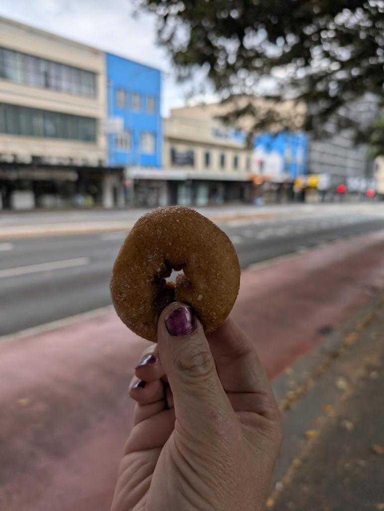 Me holding a cinnamon doughnut in the air