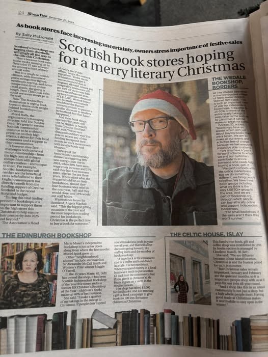 A page in The Sunday Post newspaper, featuring a large photo of a middle-aged bookseller wearing a Santa Hat.  The article urges people to buy from local bookshops. 