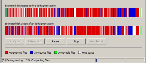 An application window with vertical bars showing the hard disk defragmentation process.