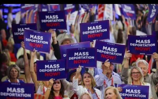 A crowd holding signs that read "MASS DEPORTATION NOW!".