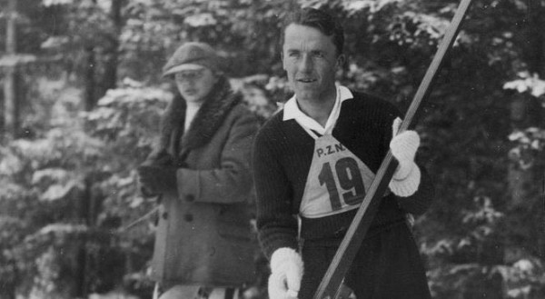 Black and white historical photo of Bronisław Czech holding skis. 