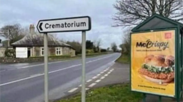 An advertisement for a McCrispy next to a Crematorium.