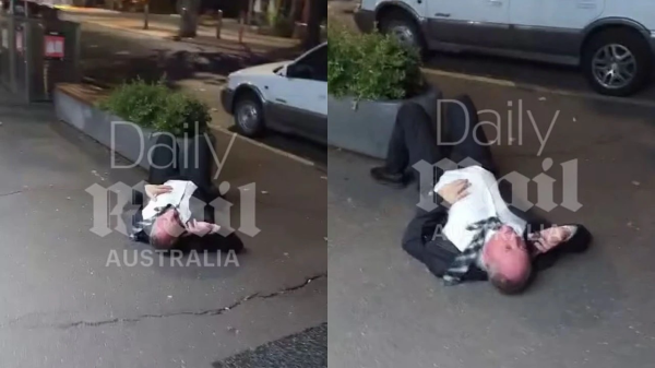 Picture of senior coalition member lying on his back on Lonsdale street Canberra yelling on his phone. 