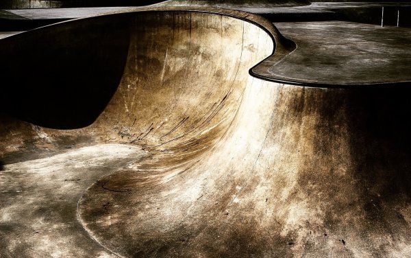 Color photo showing the wave-like forms and surfaces of an urban skatepark.