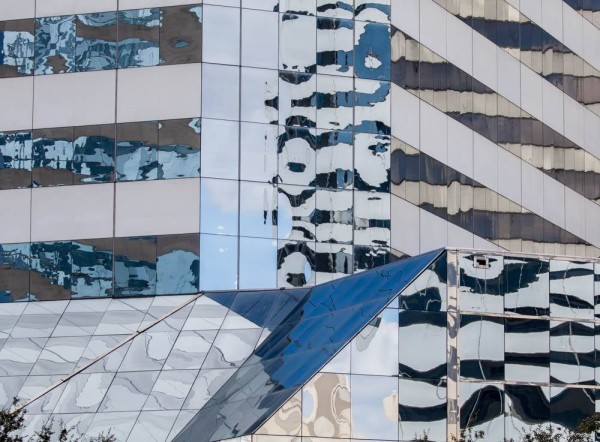 Glass on the side of a Building showing distorted reflections.