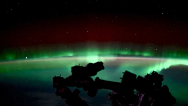 A green aurora simes over the curvature of Earth%2D seen from a low orbit.