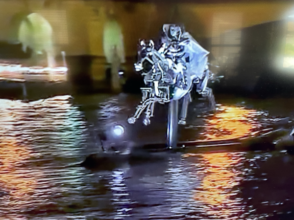 Front view of mechanized horse and rider transporting the Olympic flag up the Seine to where the athletes are