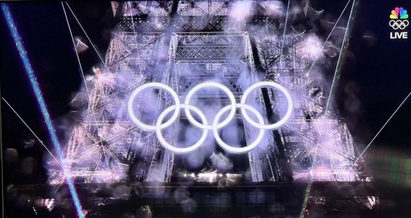 Eiffel Tower light show with the Olympic Rings glowing.