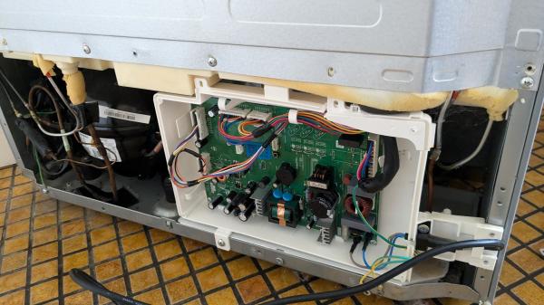 Back of a fridge, the lower section, with the shielding cover off and the control circuitry box open