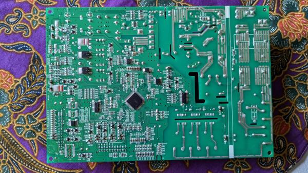 Back of the same fridge control board showing the many surface mount electronics