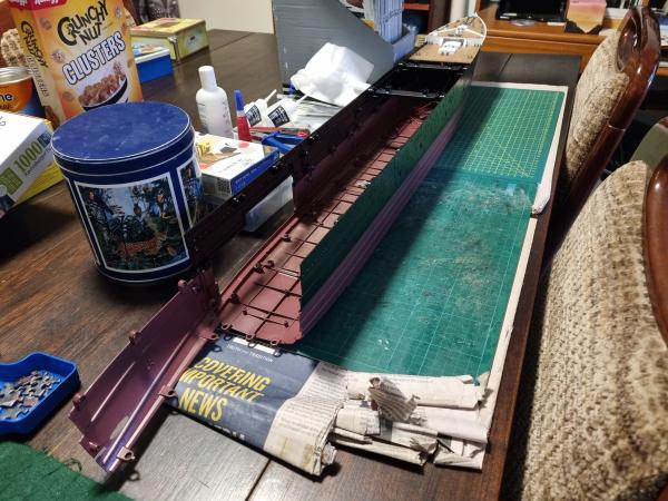 Hull of a model Titanic with another section added on the lefthand side.