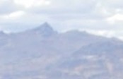 A Zoomed photo of one small peak in the small range of mountains in the background of the first photo above