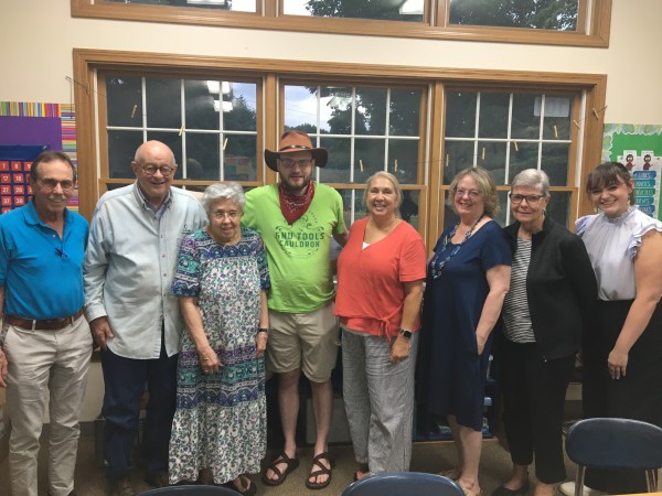 Group photo of several Democrats standing together in a classroom