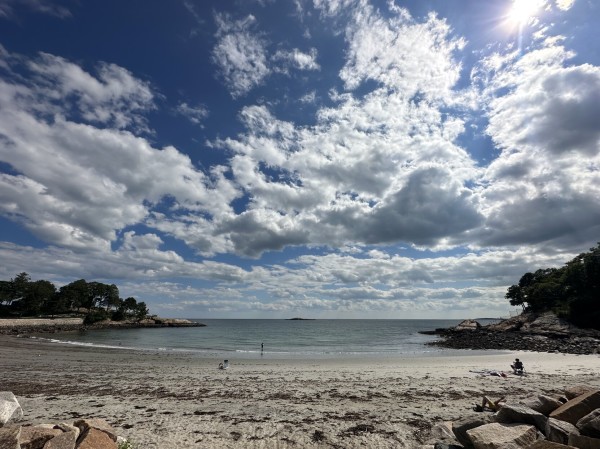 A wide-angle photo of dramatic clouds in n a bright sky over White Beach, #Manchester #Massachusetts.