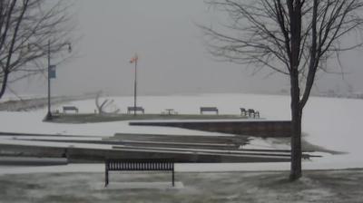 View looking northeast of the Oconto boat ramp and windsock in the foreground, with the breakwaters stretching into Sturgeon Bay behind it. // Image captured at: 2024-12-19 20:50:42 UTC (about 12 min. prior to this post) // Current Temp in Oconto: 26.69 F | -2.95 C // Precip: snow // Wind: N at 0 mph | 0 kph // Humidity: 93%