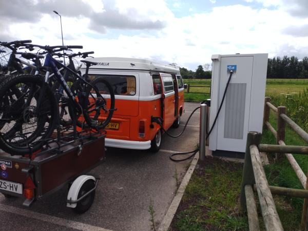 Converted VW T2 Westfalia from 1979. Leaf engine and new 66kWh batteries under the floor, capable of 45kW CCS charging.

Picture shows the with over orange bus charging at a fast charger someplace in France