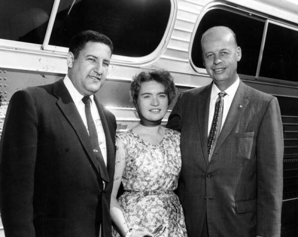 Photograph caption dated July 29, 1957 reads, "Josianne Strainchamps, 19-year-old Belgian student, arrives in Valley for eight-week visit as guest of Panorama City Rotary Club which sponsors yearly visits of foreign students.  Greeting her are Dr. Howard Mark, left, president of the club, and Bjarne Larsen, right, district governor of Rotary District 526.  Josianne is studying to be teacher in Belgian Congo."