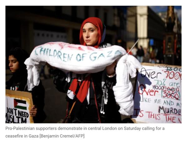 protestor holding shroud labelled gaza's children