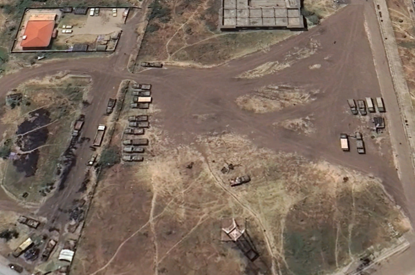 At least twenty military pickup trucks on the premises of Woldia's stadium, in what was once a fan parking lot.