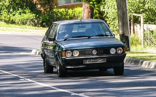 VW Passat in British Racing Green dragging himself up the road.