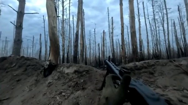 Ukrainian soldier of the "Combat Action" unit holds his trench with a MG-3 while beeing under enemy fire. December 2024