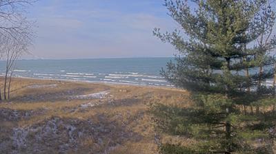 A dry, grassy hillside with a single pine and a few trees beyond which the lake is visible to the horizon. A tiny strip of beach is just visible at the bottom of the hill. // Image captured at: 2024-12-21 20:29:53 UTC (about 3 min. prior to this post) // Current Temp in Gary: 27.47 F | -2.52 C // Precip: clear sky // Wind: NNW at 6.912 mph | 11.12 kph // Humidity: 63%