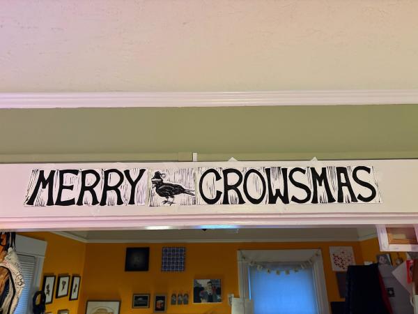 Banner that says MERRY CROWSMAS