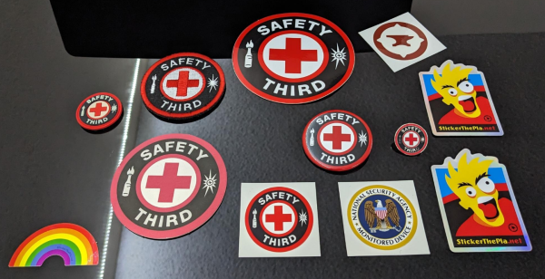 A picture of several stickers and patches related to safety third from stickerthepla.net