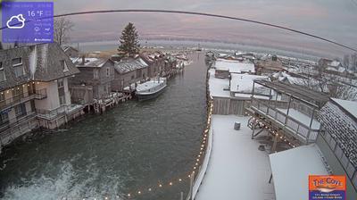 View of the outdoor dining area for The Cove Restaurant and the larger Fishtown complex overlooking a channel leading to Lake Michigan. // Image captured at: 2024-12-22 13:27:31 UTC (about 5 min. prior to this post) // Current Temp in Leland: 17.96 F | -7.80 C // Precip: scattered clouds // Wind: S at 10.648 mph | 17.13 kph // Humidity: 75%