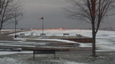 View looking northeast of the Oconto boat ramp and windsock in the foreground, with the breakwaters stretching into Sturgeon Bay behind it. // Image captured at: 2024-12-22 21:56:07 UTC (about 6 min. prior to this post) // Current Temp in Oconto: 26.69 F | -2.95 C // Precip: overcast clouds // Wind: SSE at 10.357 mph | 16.66 kph // Humidity: 59%