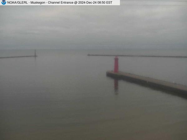 View of Muskegon breakwater in the distance, and the red South Lighthouse defining the entrance of the Muskegon Channel in the foreground. // Image captured at: 2024-12-24 13:50:01 UTC (about 13 min. prior to this post) // Current Temp in Muskegon: 32.73 F | .41 C // Precip: overcast clouds // Wind: NE at 5.010 mph | 8.06 kph // Humidity: 79%