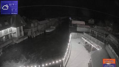 View of the outdoor dining area for The Cove Restaurant and the larger Fishtown complex overlooking a channel leading to Lake Michigan. // Image captured at: 2024-12-25 12:31:25 UTC (about 1 min. prior to this post) // Current Temp in Leland: 30.02 F | -1.10 C // Precip: overcast clouds // Wind: S at 8.254 mph | 13.28 kph // Humidity: 84%